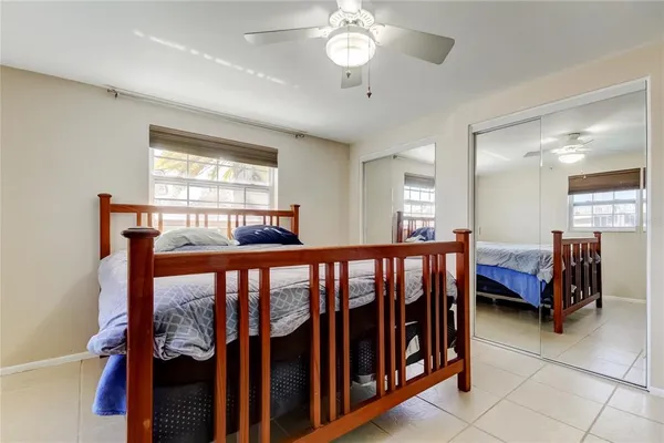 a bedroom with furniture and a large window