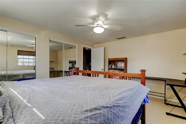 a bedroom with a bed and a chandelier