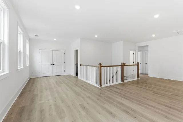 a view of an empty room with wooden floor
