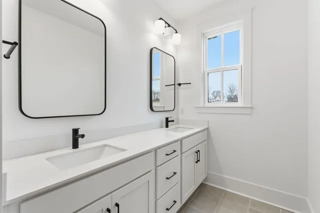 a bathroom with a double vanity sink and a mirror
