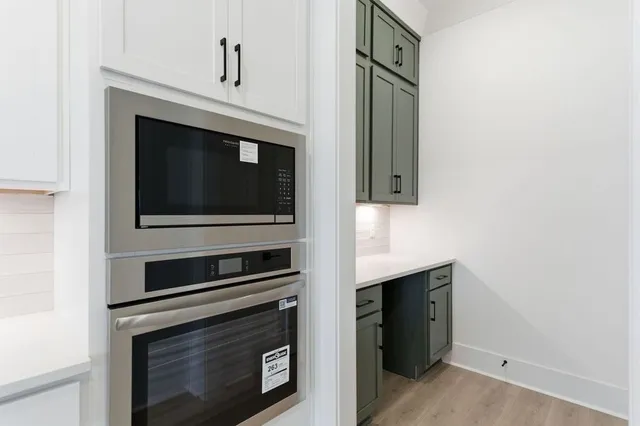 a kitchen with granite countertop cabinets and steel stainless steel appliances