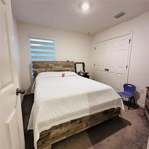 a bedroom with a bed and closet