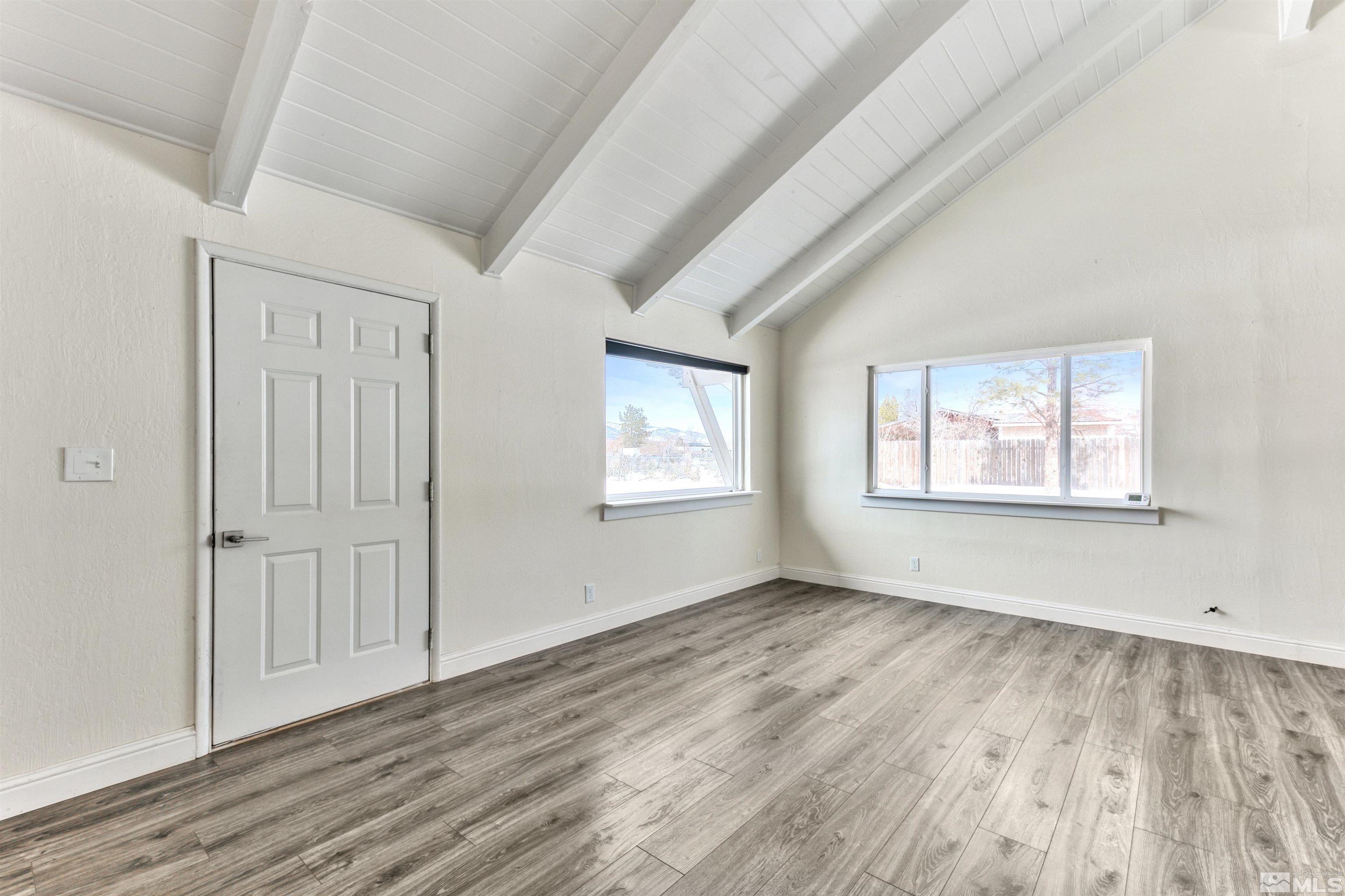 3900 Ormsby Place Washoe Valley, NV 89704 - Photo 16 of 18 an empty room with wooden floor and windows