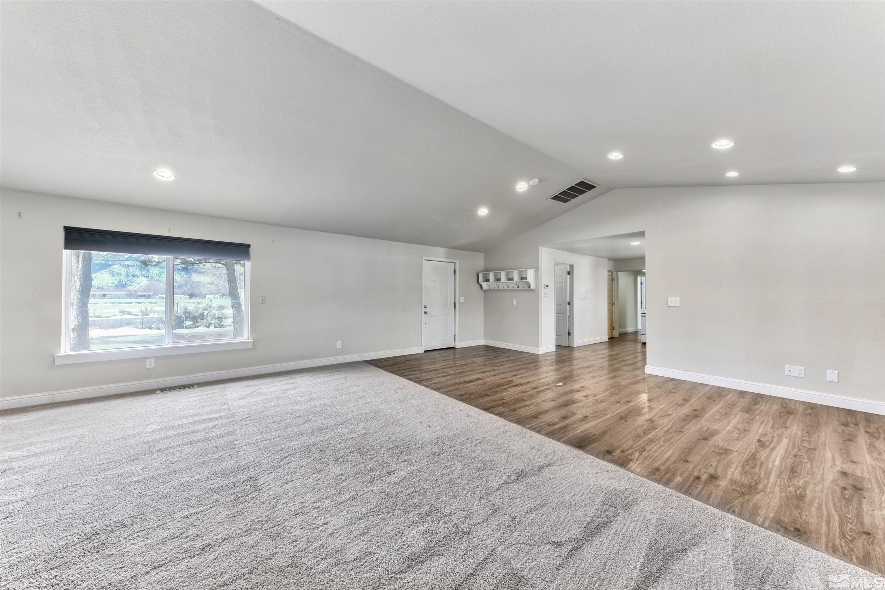 3900 Ormsby Place Washoe Valley, NV 89704 - Photo 6 of 18 an empty room with wooden floor and windows