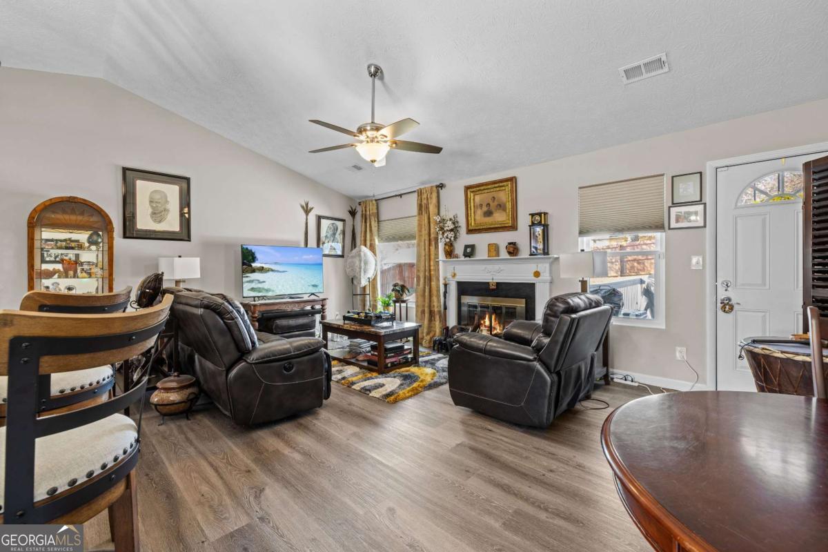 6324 Amberly Road Rex, GA 30273 - Photo 8 of 22 a living room with furniture a fireplace and a window