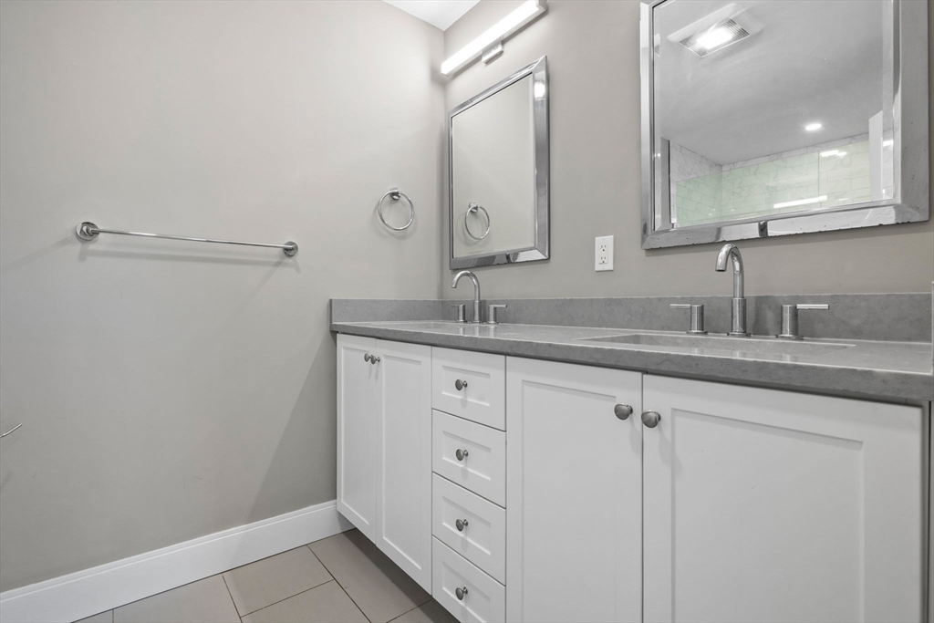 3 Burke Lane, Unit 203 Wellesley, MA 02481 - Photo 13 of 23 a bathroom with a sink and a mirror