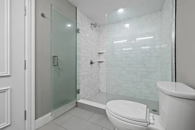 a bathroom with a toilet and a shower