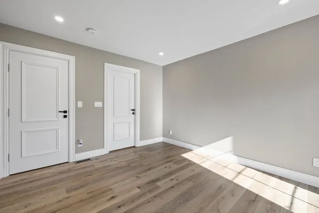 a view of wooden floor and windows in a room