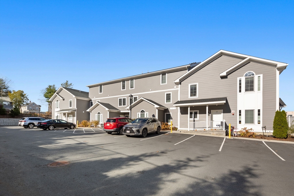 3 Burke Lane, Unit 203 Wellesley, MA 02481 - Photo 21 of 23 a car parked in front of a house