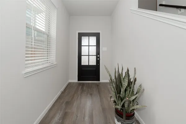 a view of a room with wooden floor and plant