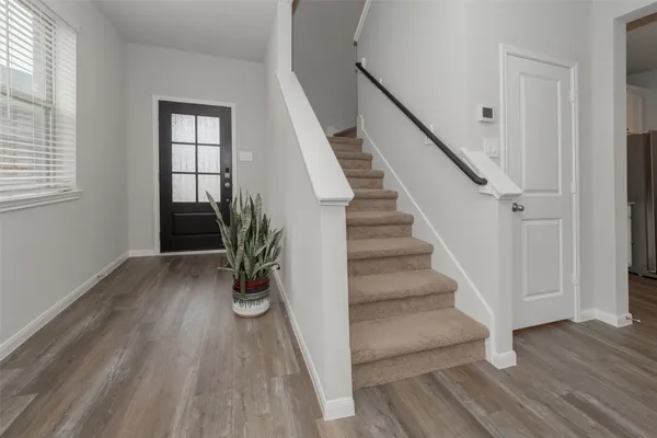 a view of entryway with wooden floor