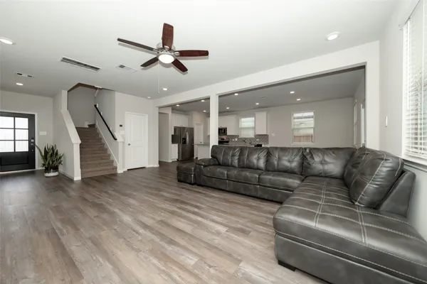 a living room with furniture and wooden floor