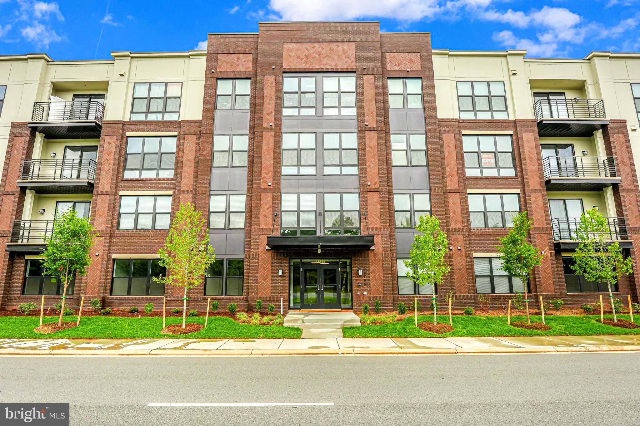 a view of a brick building next to a yard
