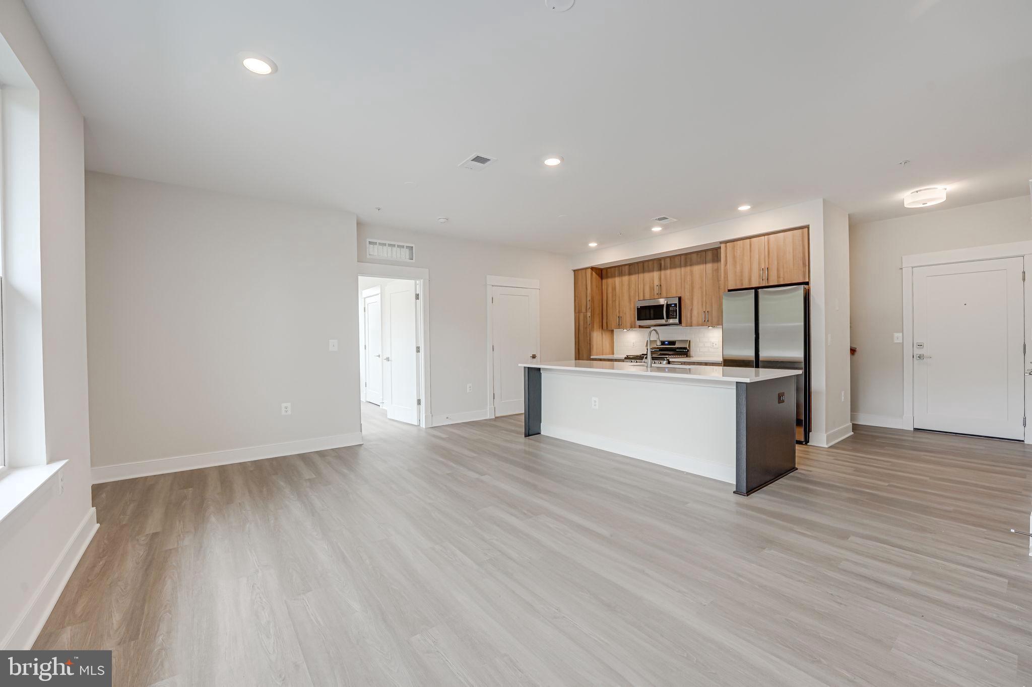 43795 Transit Square, Unit 101 Ashburn, VA 20147 - Photo 11 of 35 a view of kitchen with wooden floor