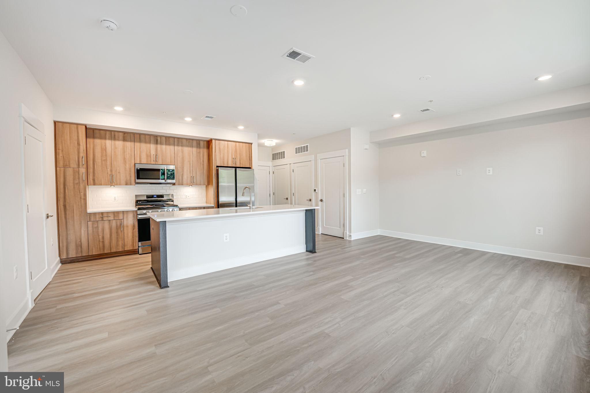 43795 Transit Square, Unit 101 Ashburn, VA 20147 - Photo 12 of 35 a view of kitchen with granite countertop stainless steel appliances refrigerator and cabinets