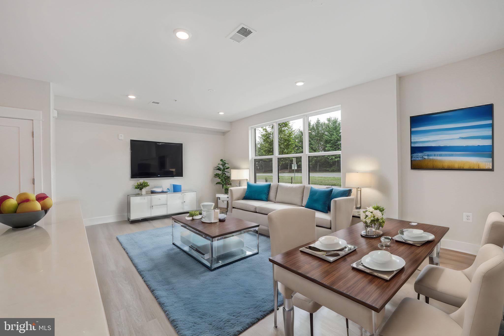 43795 Transit Square, Unit 101 Ashburn, VA 20147 - Photo 13 of 35 a living room with furniture and a flat screen tv