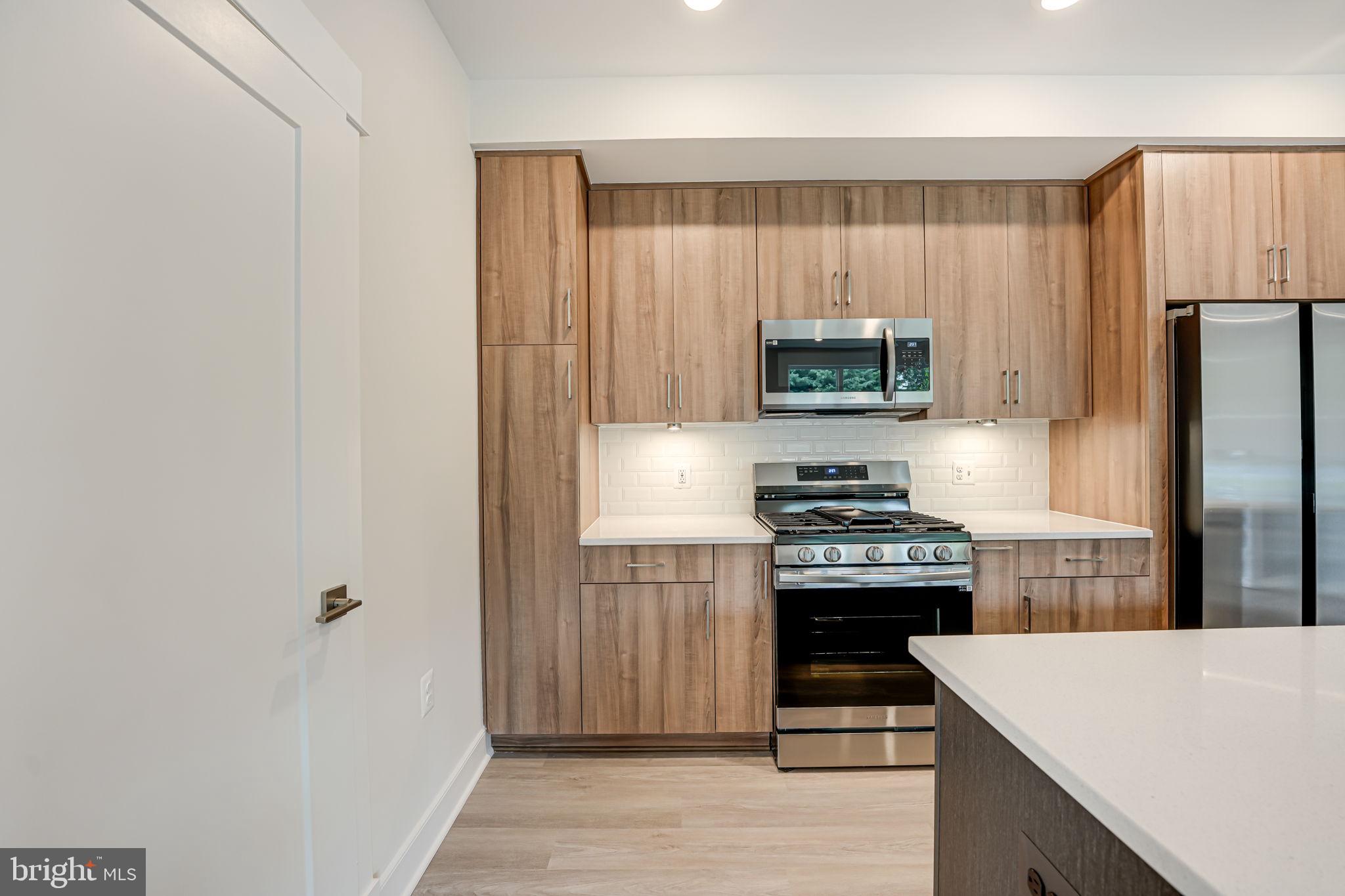 43795 Transit Square, Unit 101 Ashburn, VA 20147 - Photo 17 of 35 a kitchen with stainless steel appliances granite countertop a stove and a refrigerator