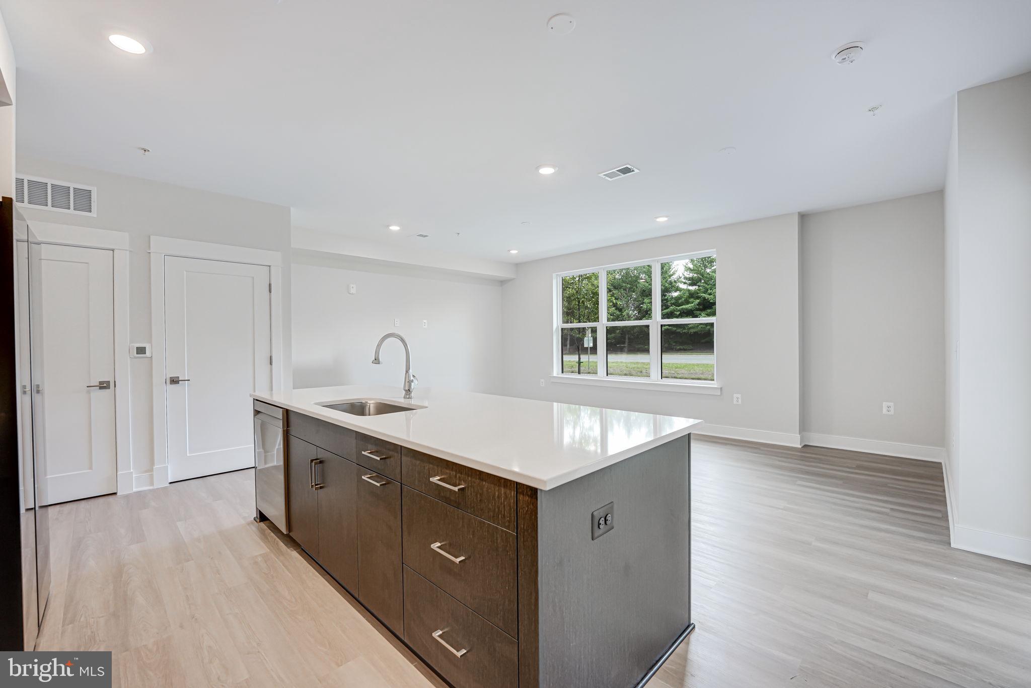 43795 Transit Square, Unit 101 Ashburn, VA 20147 - Photo 21 of 35 a kitchen with sink cabinets and window