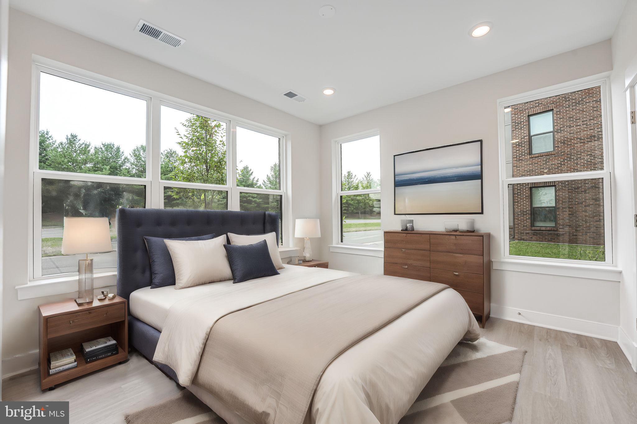 43795 Transit Square, Unit 101 Ashburn, VA 20147 - Photo 23 of 35 a bedroom with a large bed and a large window