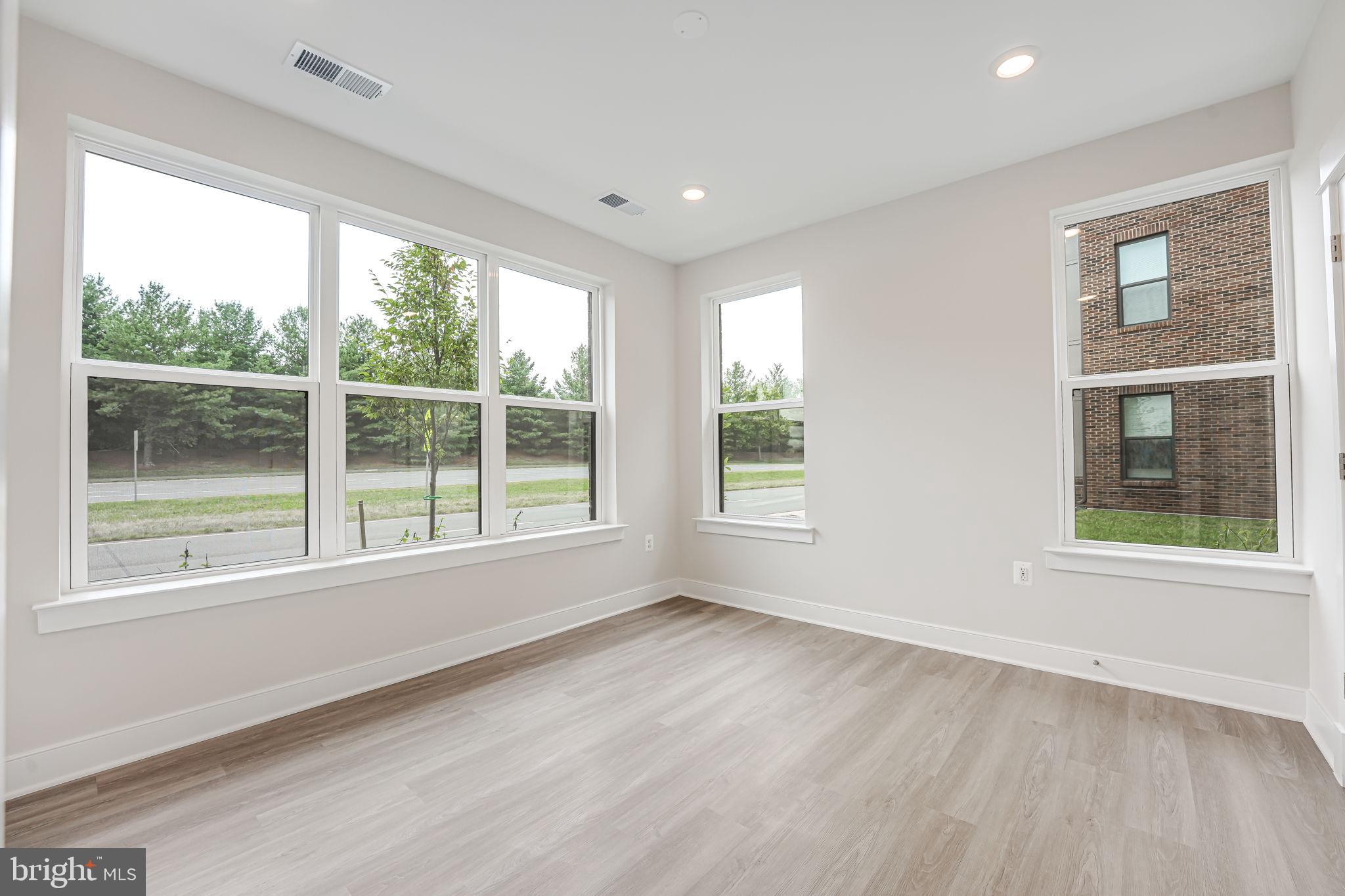 43795 Transit Square, Unit 101 Ashburn, VA 20147 - Photo 24 of 35 a view of empty room with wooden floor and fan