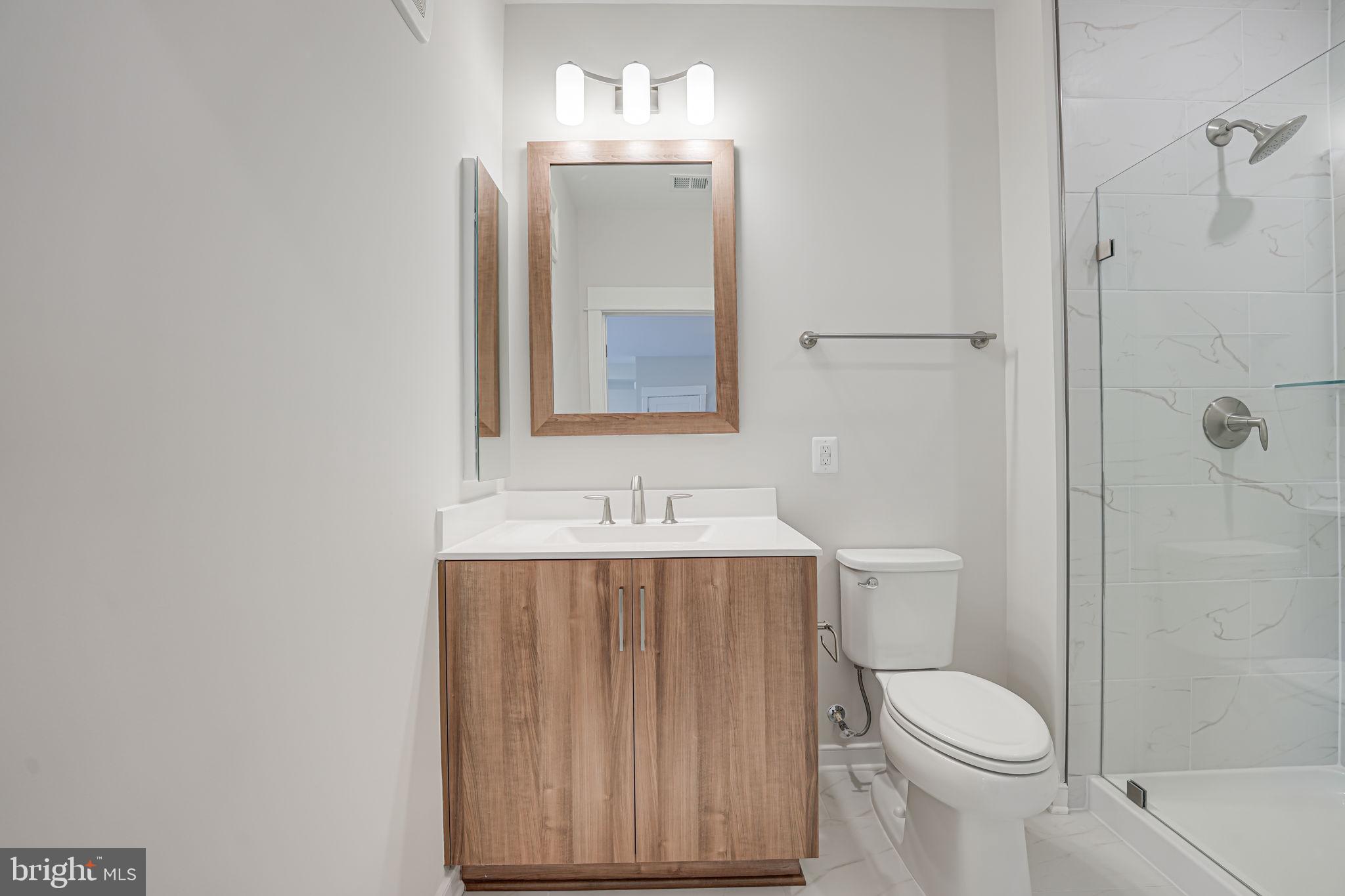 43795 Transit Square, Unit 101 Ashburn, VA 20147 - Photo 27 of 35 a bathroom with a sink a toilet and shower