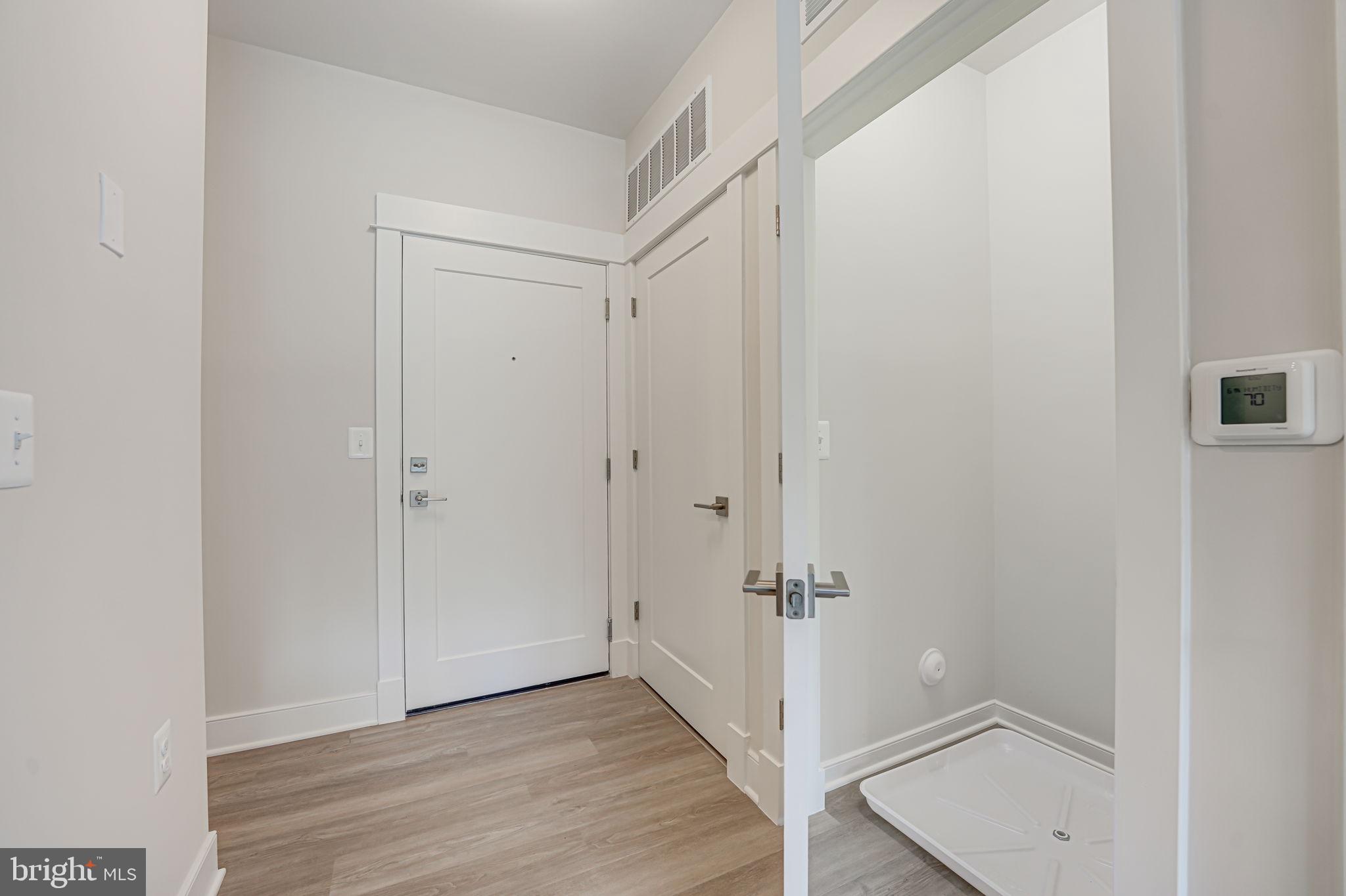 43795 Transit Square, Unit 101 Ashburn, VA 20147 - Photo 29 of 35 a view of a hallway with wooden floor