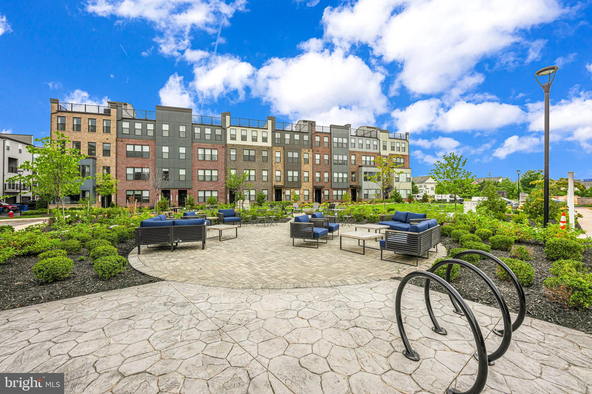43795 Transit Square, Unit 101 Ashburn, VA 20147 - Photo 30 of 35 a view of a patio with a table and chairs