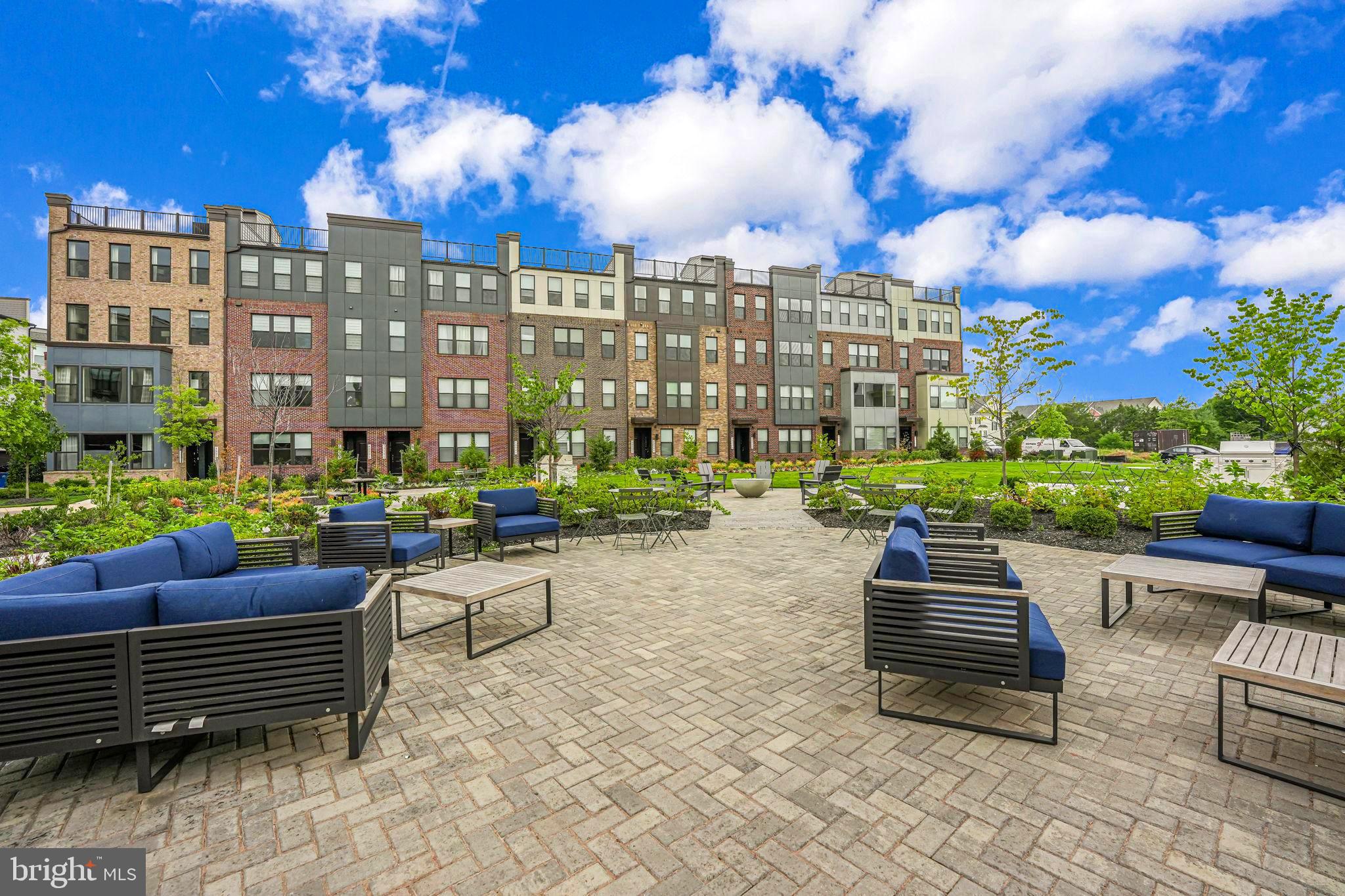 43795 Transit Square, Unit 101 Ashburn, VA 20147 - Photo 31 of 35 a view of a patio with swimming pool and table and chairs
