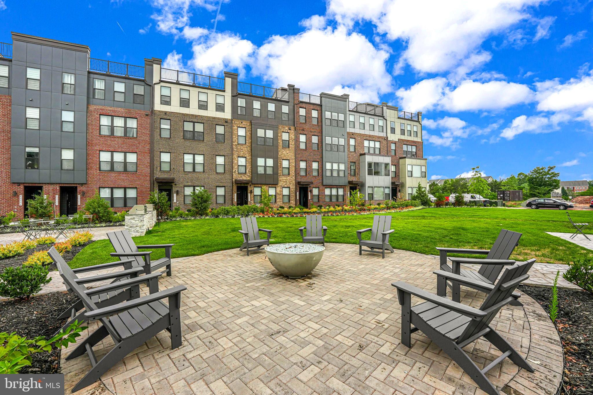 43795 Transit Square, Unit 101 Ashburn, VA 20147 - Photo 32 of 35 a view of a patio with table and chairs with plants and garden view