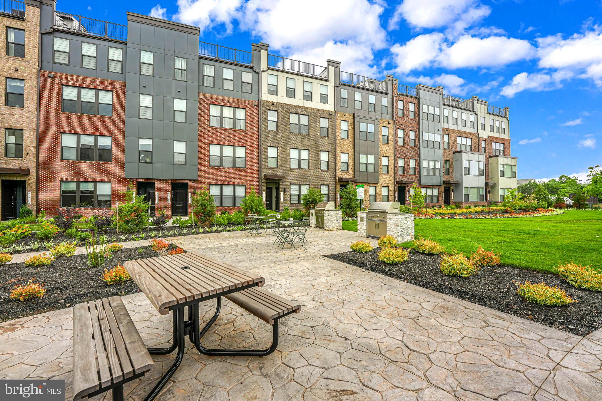 43795 Transit Square, Unit 101 Ashburn, VA 20147 - Photo 33 of 35 a view of a building with garden and sitting area