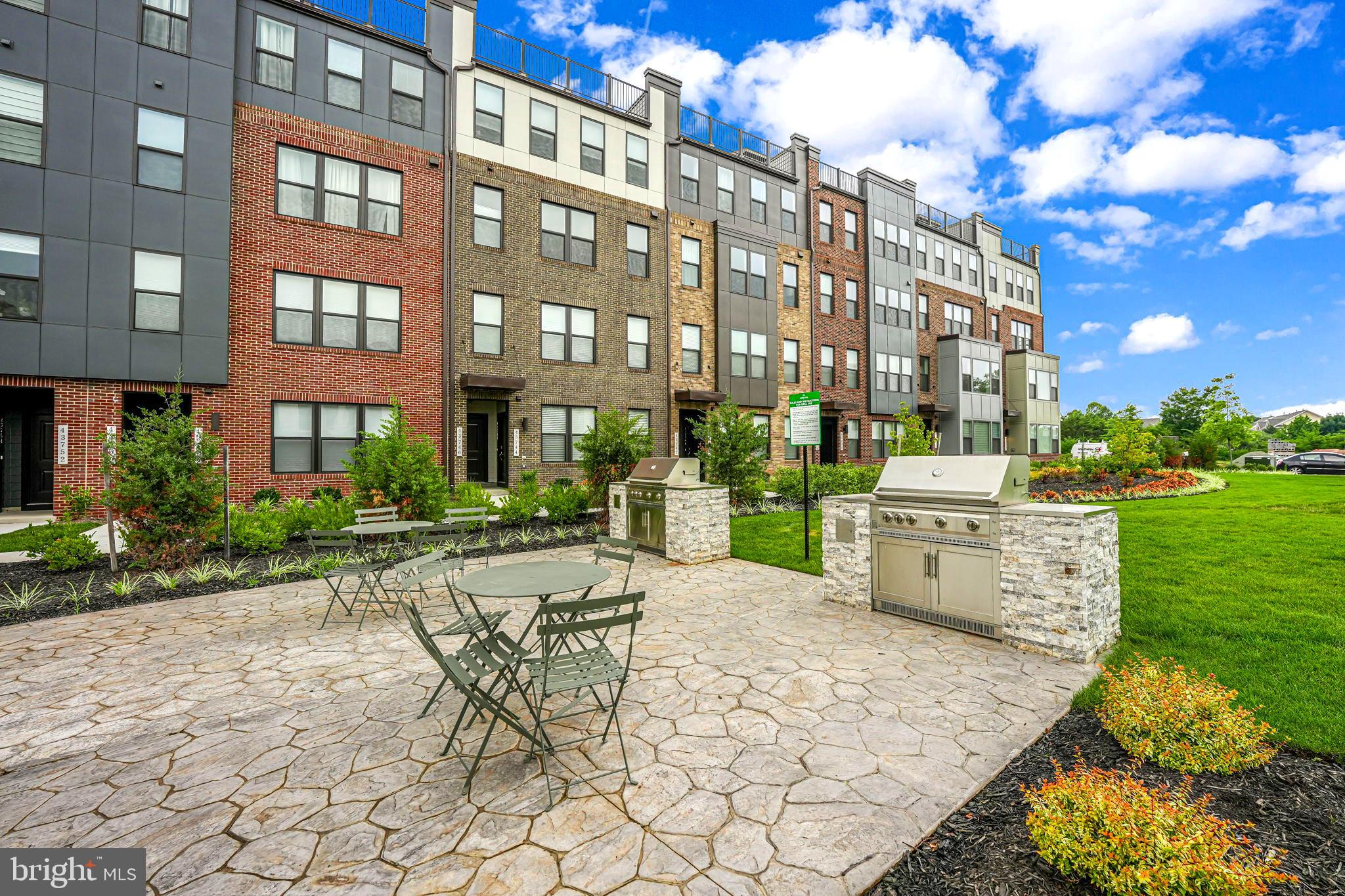 43795 Transit Square, Unit 101 Ashburn, VA 20147 - Photo 34 of 35 a view of a building with backyard and sitting area