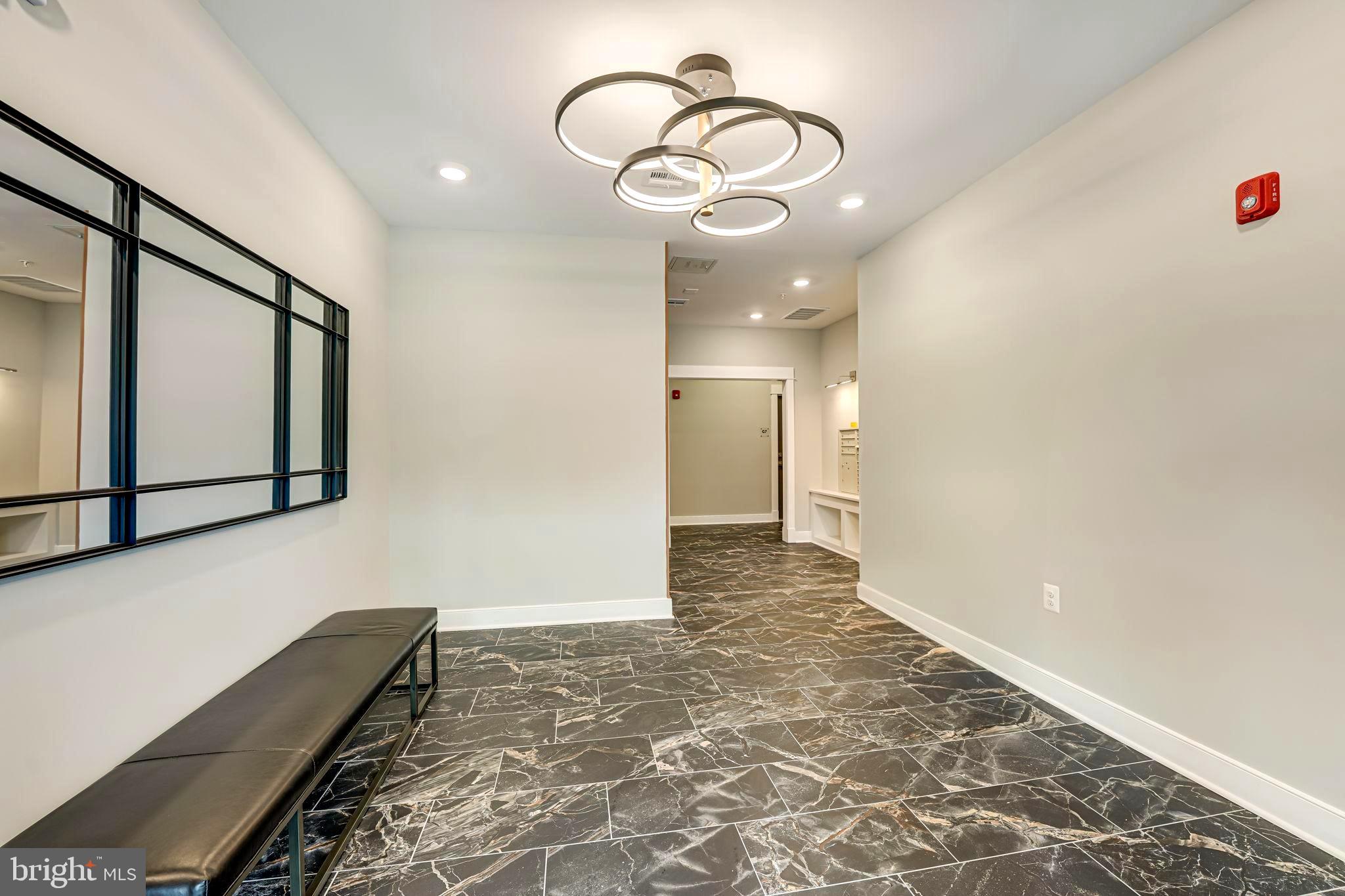 43795 Transit Square, Unit 101 Ashburn, VA 20147 - Photo 6 of 35 a view of a hallway with wooden floor