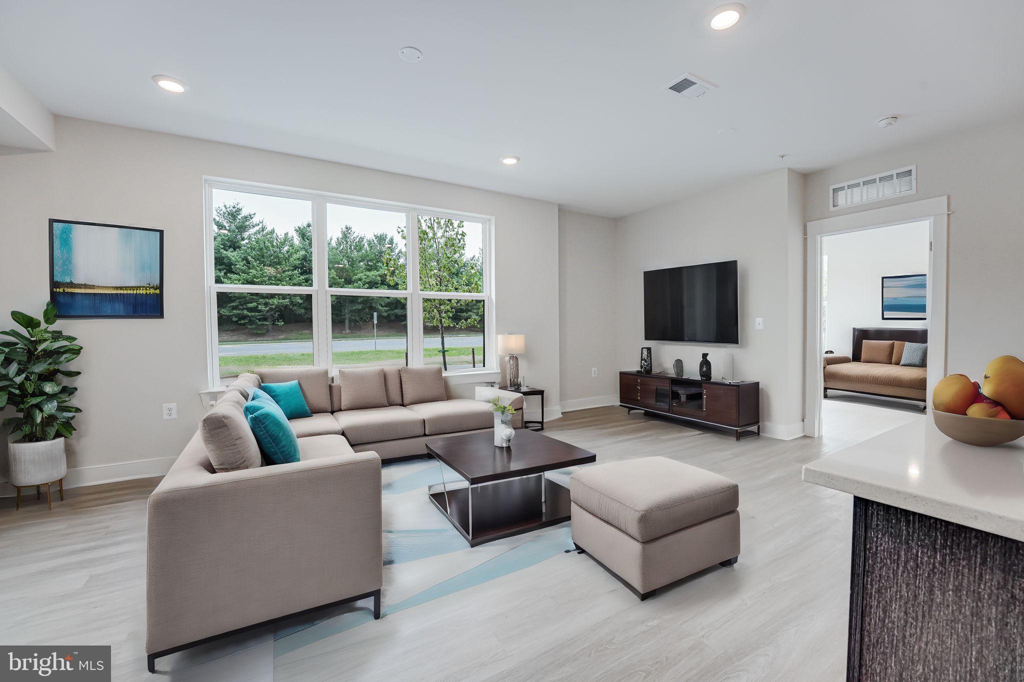43795 Transit Square, Unit 101 Ashburn, VA 20147 - Photo 8 of 35 a living room with furniture and a flat screen tv