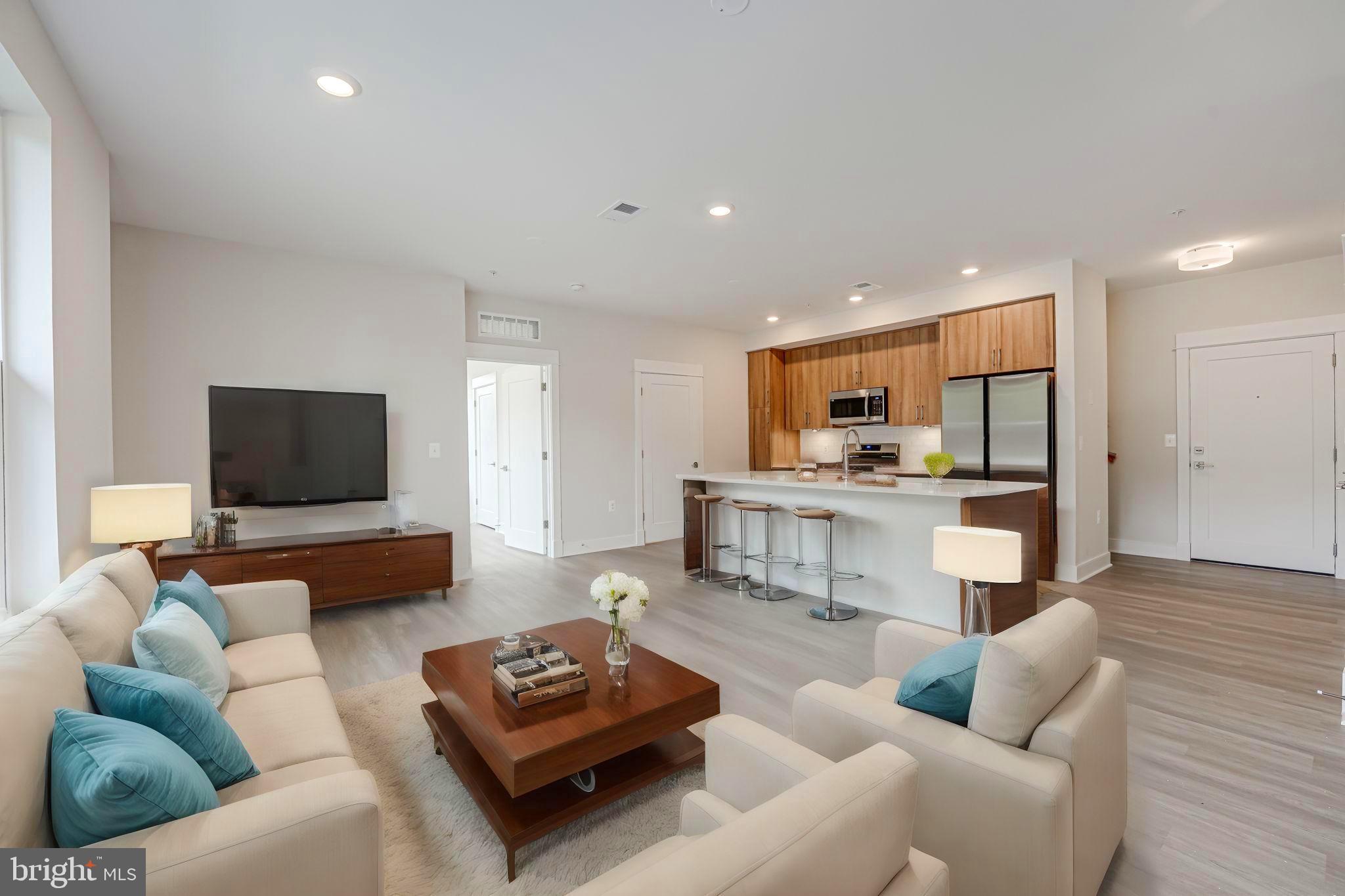 43795 Transit Square, Unit 101 Ashburn, VA 20147 - Photo 10 of 35 a living room with furniture and a flat screen tv
