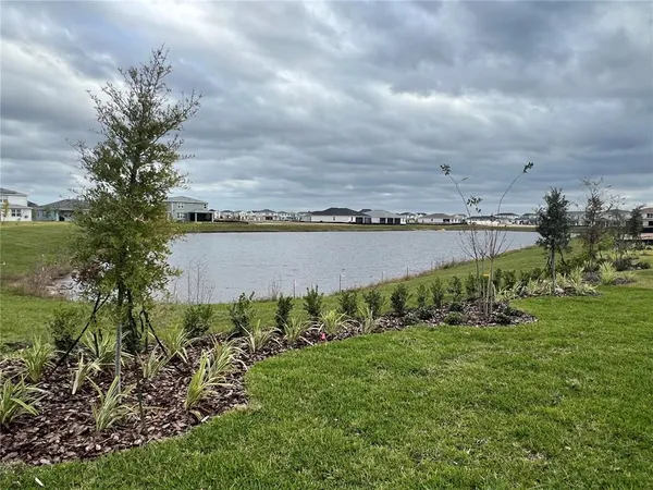 a view of a lake with a table and chairs
