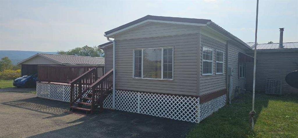 140 Firestone Road Smithfield, PA 15478 - Photo 8 of 33 a brick house with a small yard and a large window