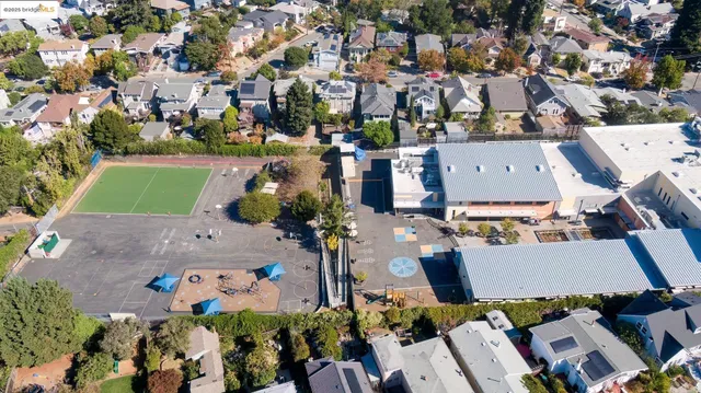 an aerial view of residential house with green space