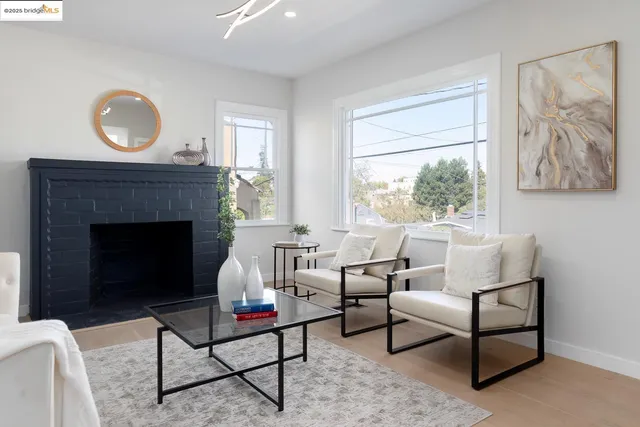 a living room with furniture a window and a fireplace