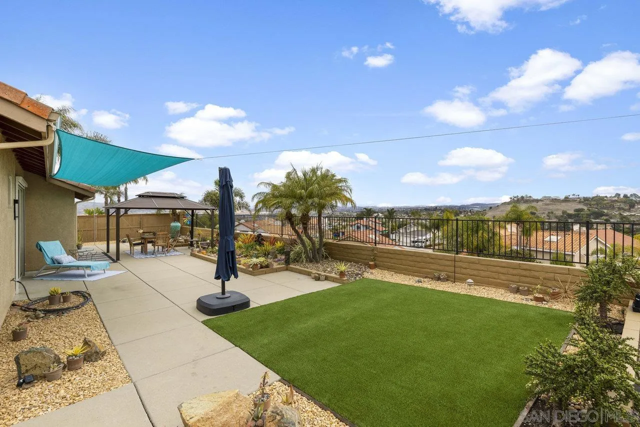 5167 Avenida De La Plata Oceanside, CA 92057 - Photo 11 of 53 a view of a patio with a table and chairs under an umbrella