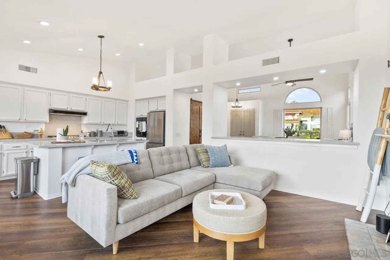 5167 Avenida De La Plata Oceanside, CA 92057 - Photo 18 of 53 a living room with furniture kitchen and a chandelier