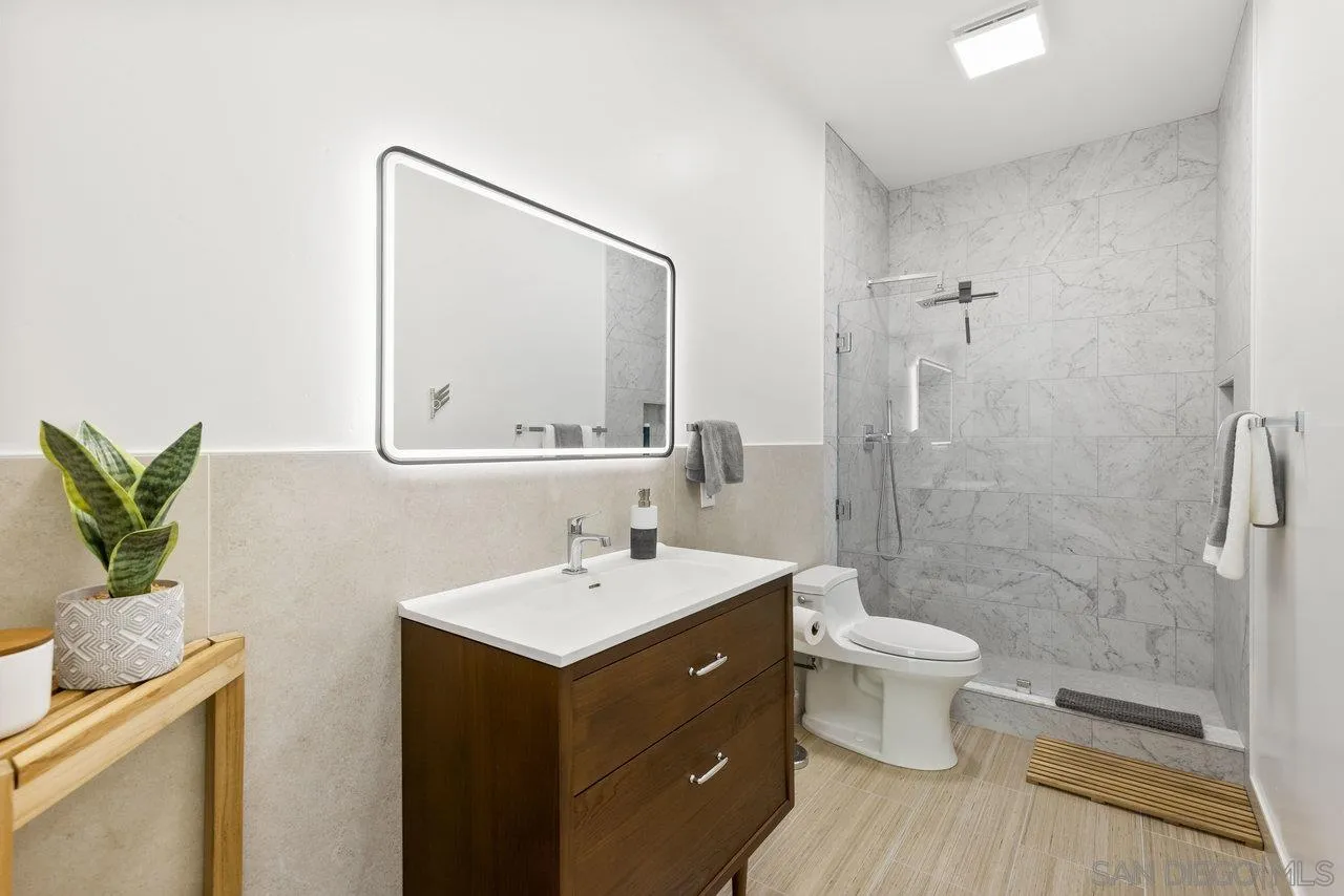 5167 Avenida De La Plata Oceanside, CA 92057 - Photo 20 of 53 a bathroom with a toilet sink and mirror