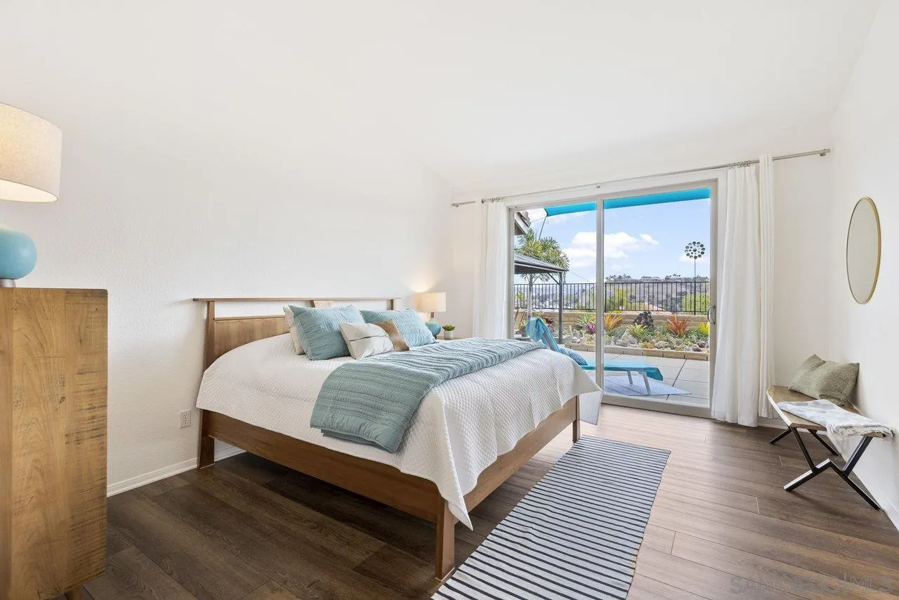 5167 Avenida De La Plata Oceanside, CA 92057 - Photo 21 of 53 a bedroom with a large bed and a large window