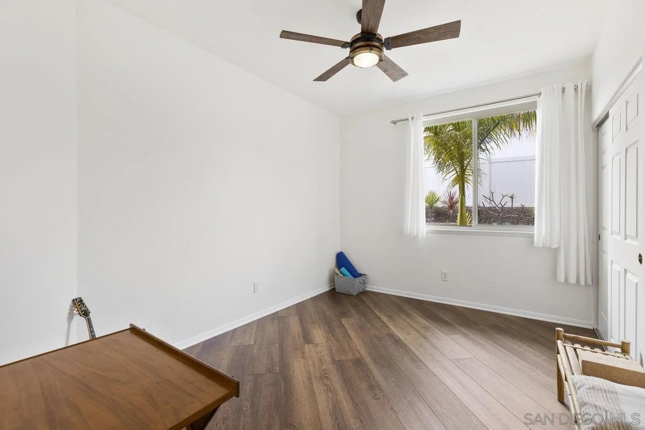 5167 Avenida De La Plata Oceanside, CA 92057 - Photo 27 of 53 a view of empty room with wooden floor and fan