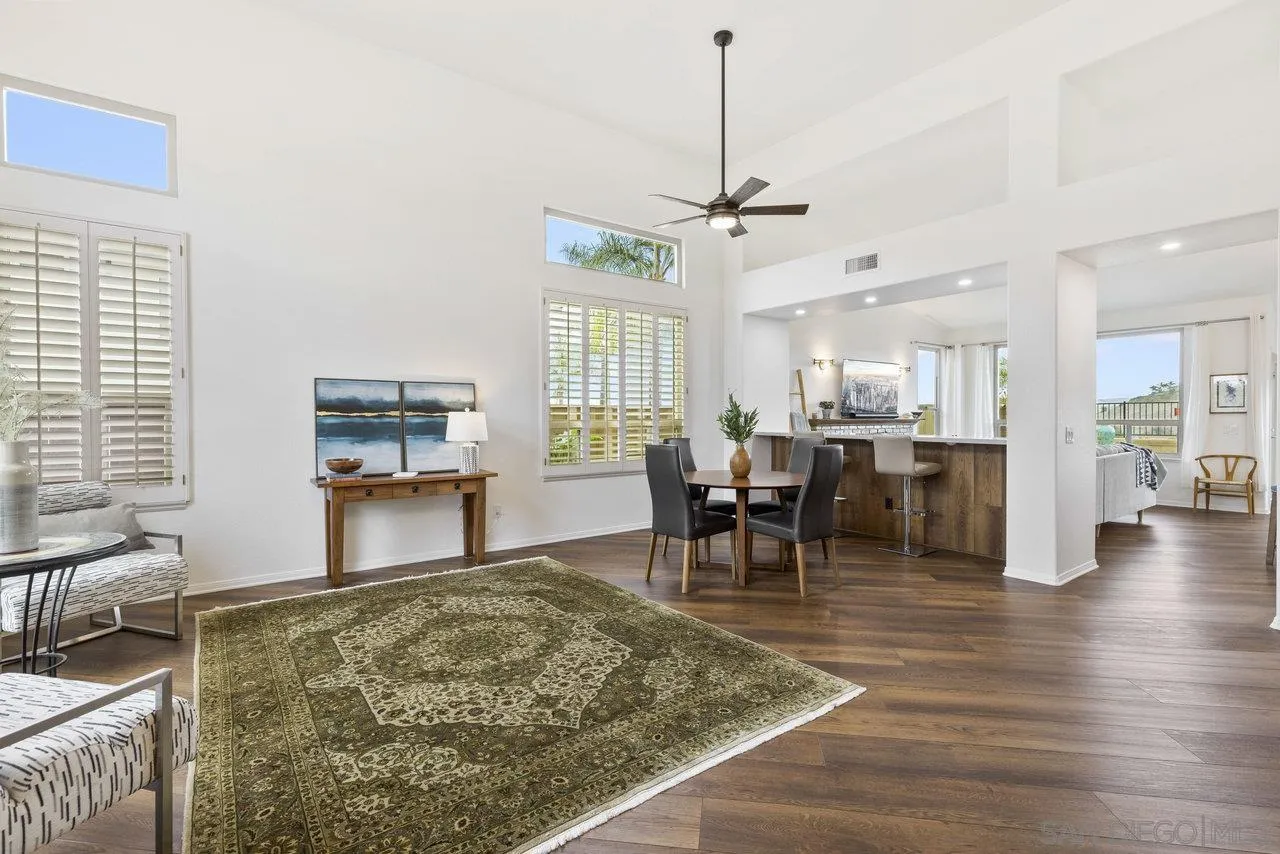 5167 Avenida De La Plata Oceanside, CA 92057 - Photo 34 of 53 a view of a dining room and livingroom with furniture wooden floor a chandelier