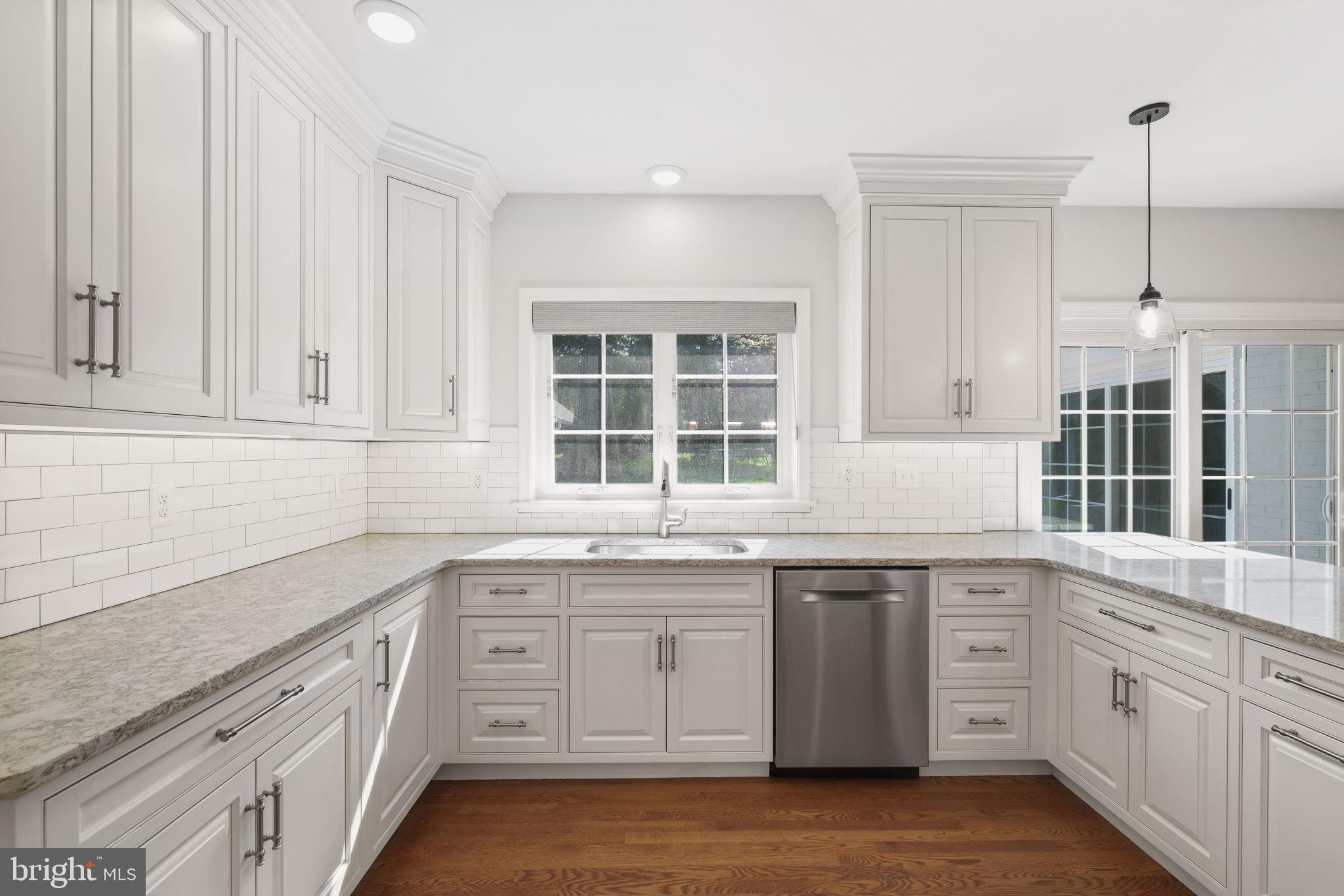 11005 Luxmanor Road North Bethesda, MD 20852 - Photo 3 of 49 a kitchen with granite countertop white cabinets and window