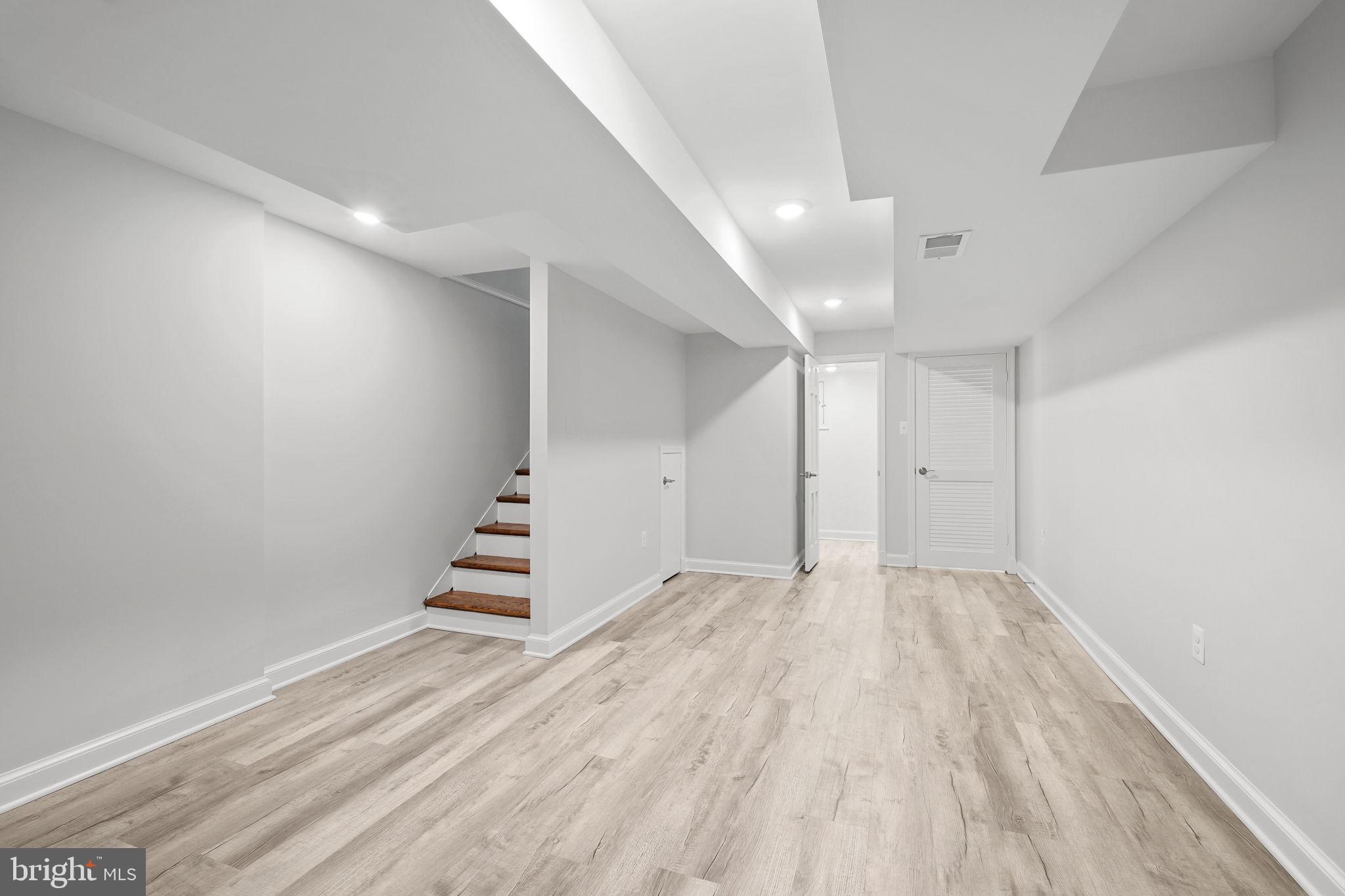 11005 Luxmanor Road North Bethesda, MD 20852 - Photo 31 of 49 wooden floor in an empty room with stairs