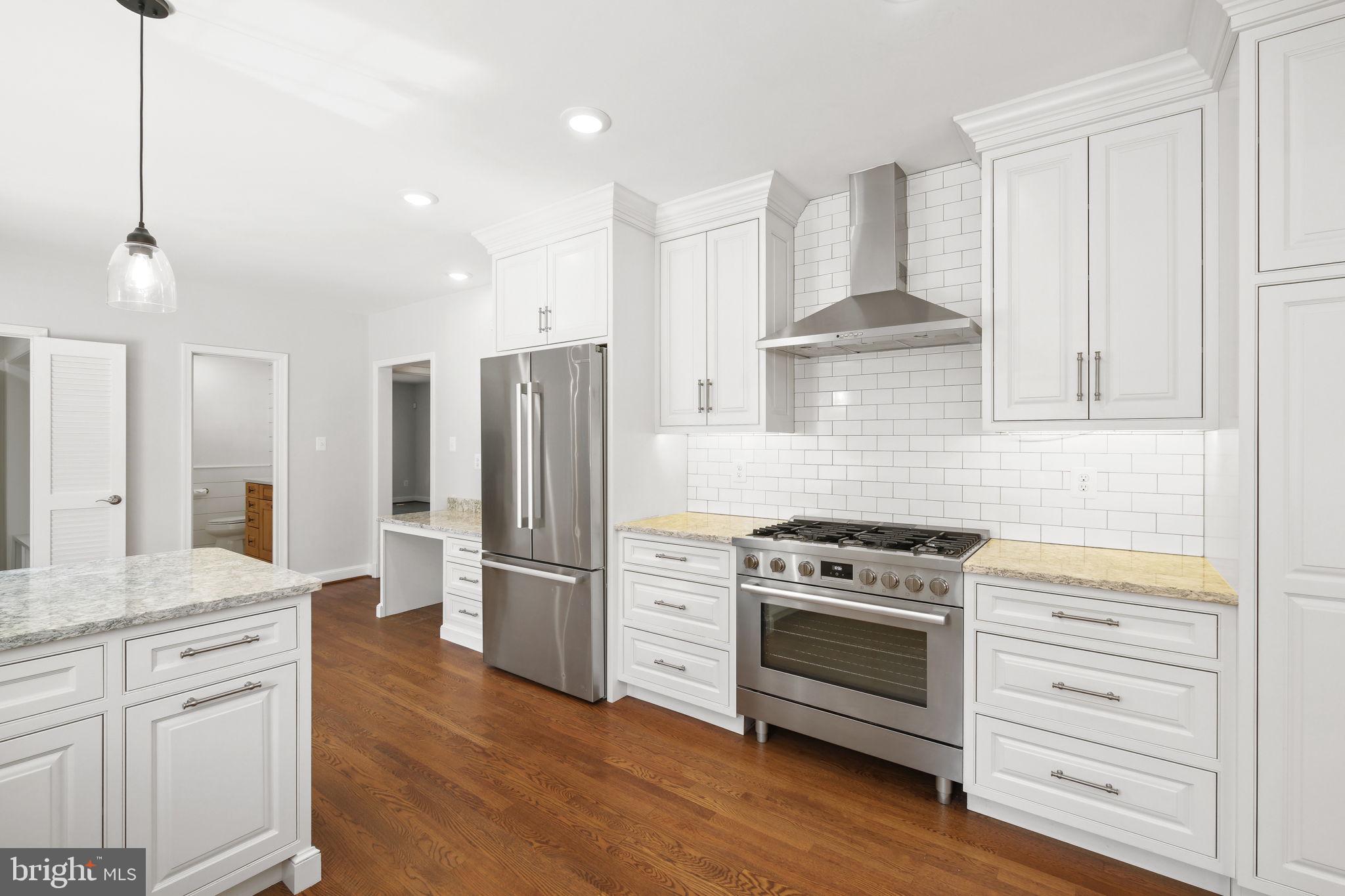 11005 Luxmanor Road North Bethesda, MD 20852 - Photo 5 of 49 a kitchen with stainless steel appliances white cabinets and a wooden floor