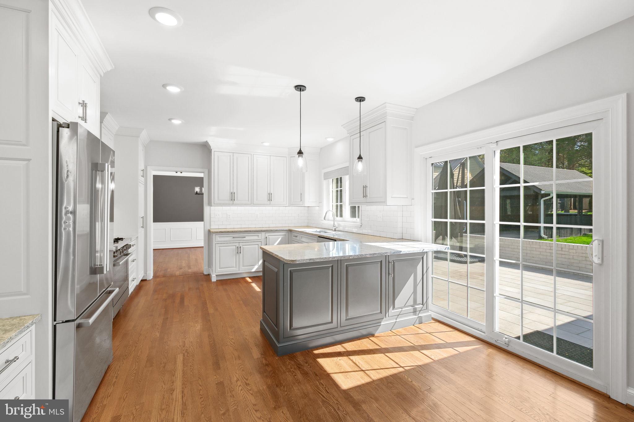 11005 Luxmanor Road North Bethesda, MD 20852 - Photo 6 of 49 a large kitchen with kitchen island a large window a sink and stainless steel appliances