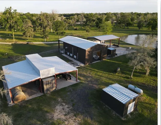 an aerial view of a house with big yard