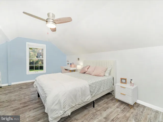 a bedroom with natural light and a bed